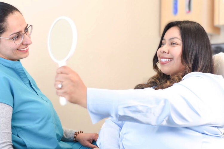 Patient smiling comfortably during a dental appointment at Mai Dental Care.
