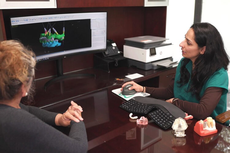 Dr. Purnima Sheoran smiling with a patient during a dental visit at Mai Dental Care
