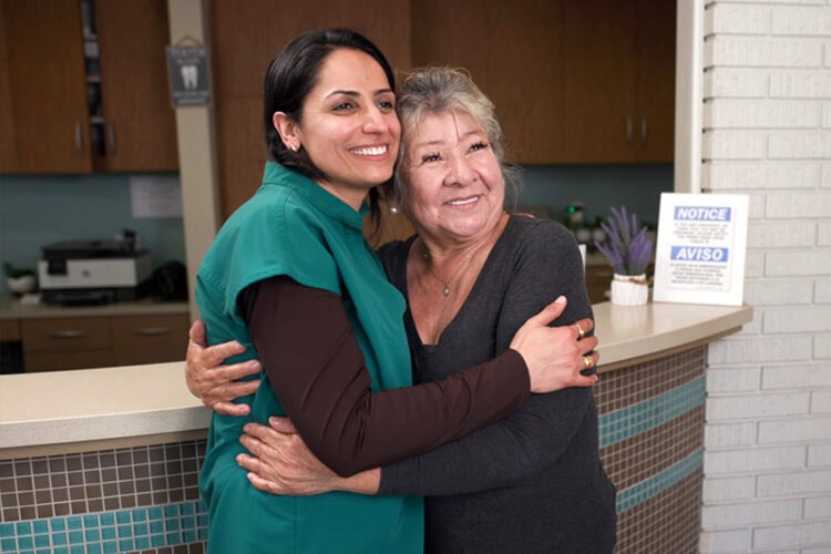 Dr. Purnima Sheoran celebrating a patient's new smile after dental treatment