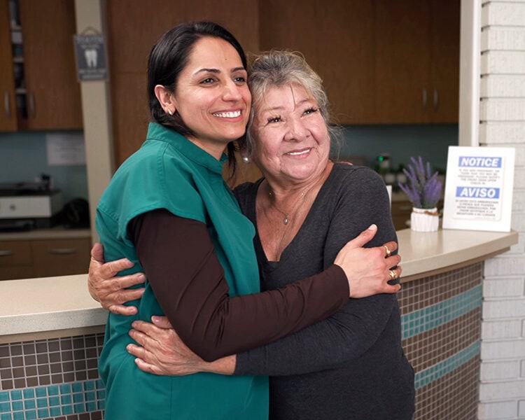 Dr. Purnima Sheoran celebrating a patient's new smile after dental treatment