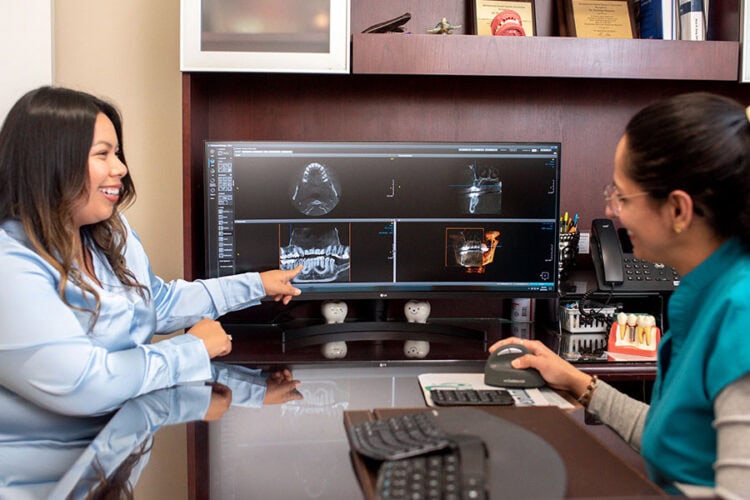 Digital dental scans displayed during an implant consultation at Mai Dental Care