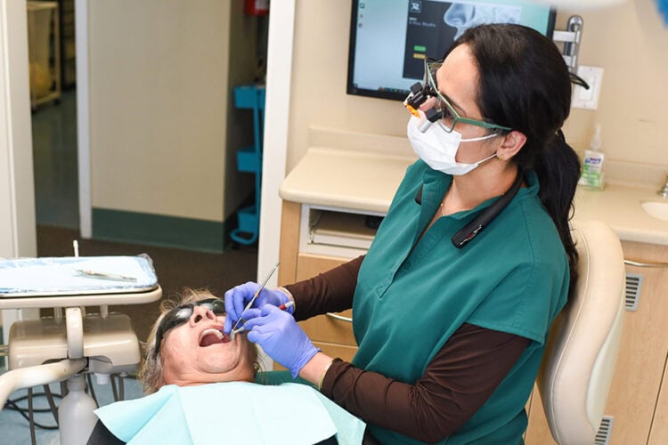 Dr. Purnima Sheoran providing a dental evaluation to a patient in Santa Maria
